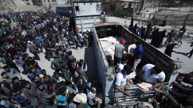 Syrian authorities distribute bread, vegetables and pasta to Douma residents.
