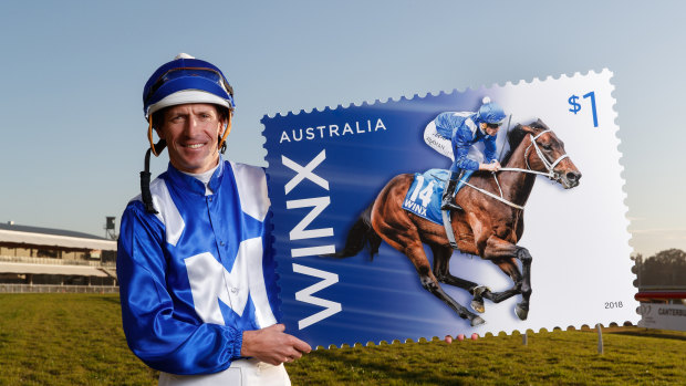 Stamp of approval: Hugh Bowman shows off the Winx stamp.