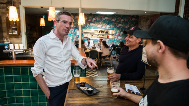 NSW Treasurer Dominic Perrottet has a beer at The Balmain Hotel with owner Justin Small as restrictions were eased on bars and pubs on Friday.