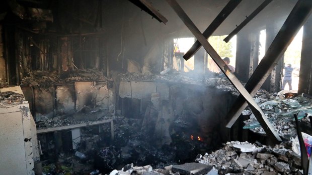 Smoke rises from the reception room of the US embassy that was burned by pro-Iranian militiamen.