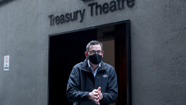 A masked Victorian Premier Daniel Andrews on his way to his press conference on Saturday. 