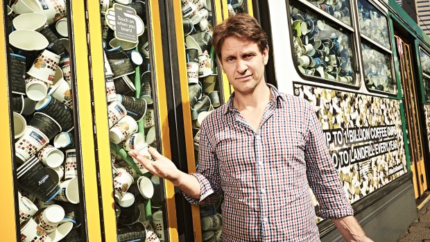 War on Waste presenter Craig Reucassel with a Melbourne tram stuffed with more than 50,000 takeaway coffee cups - representing what Australians send to landfill every half-hour.