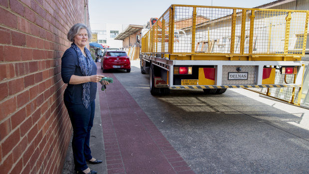 A truck backs up along an easement adjoining Karen Paxton's small business in Fyshwick. The valuation on her block went up 300 per cent in 2016-17, affecting her business.