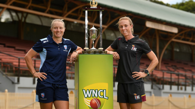 What they're fighting for: NSW skipper Alyssa Healy and Queensland Fire captain Kirby Short with the WNCL trophy.