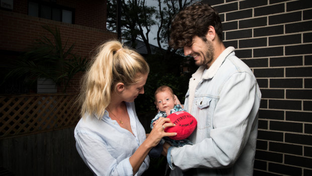 Sydney midfielder George Hewett, and Alice Summers with baby Henry.