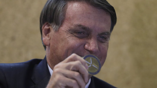 President Jair Bolsonaro shows a Niobium coin received as a gift during the launch of the Mining and Development Program in Brasilia last year.