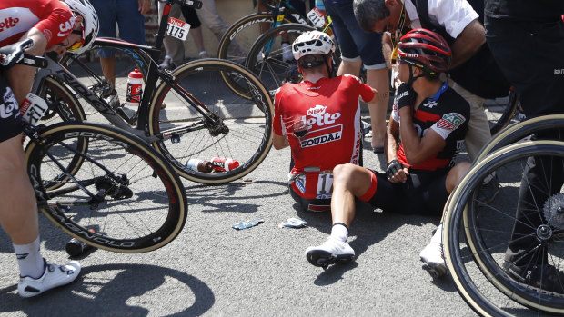 Broken man: Australia's Richie Porte, right, receives medical attention as he sits on the road.