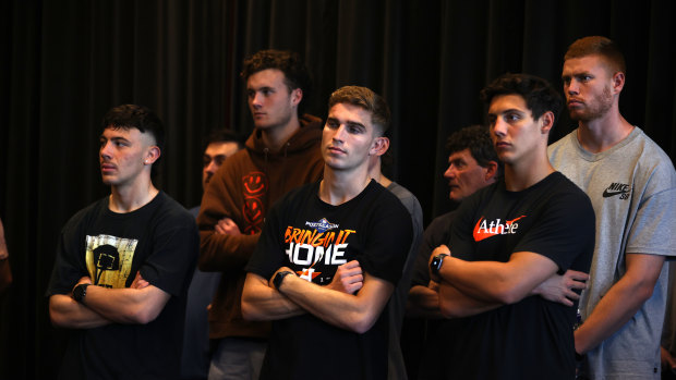 Essendon players look on during Brad Scott’s first press conference as coach on Friday.