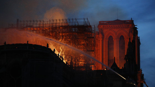 Firefighters use hoses as Notre-Dame Cathedral burns in Paris.