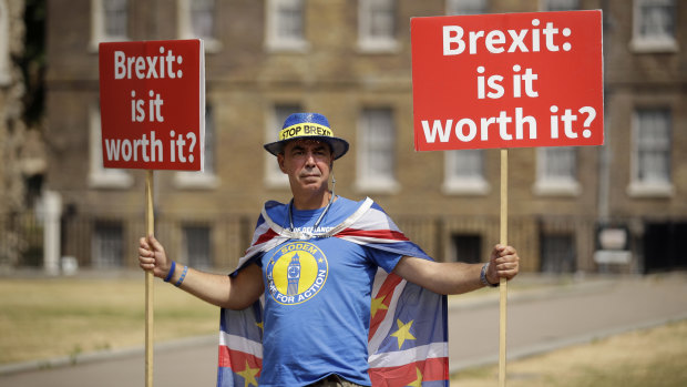 Anti-Brexit, pro-EU supporter Steve Bray holds placards across the road from the Houses of Parliament in London, on Monday.