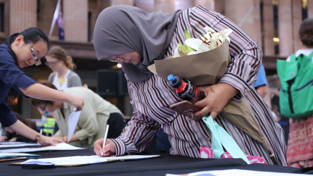 Muslima Fadia Shamseldin signing the condolence book for the Christchurch victims.