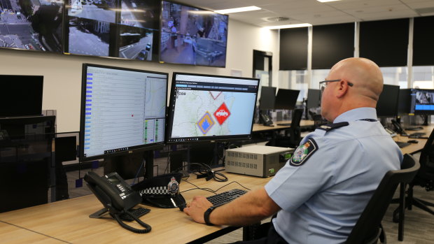 Police officers can monitor the news in an operation room.