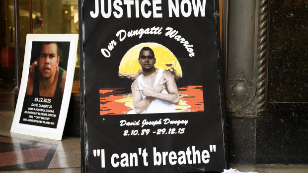 Banners reading "Justice for David Dungay" outside the Downing Centre Court in Sydney. He died in custody in 2015. 

