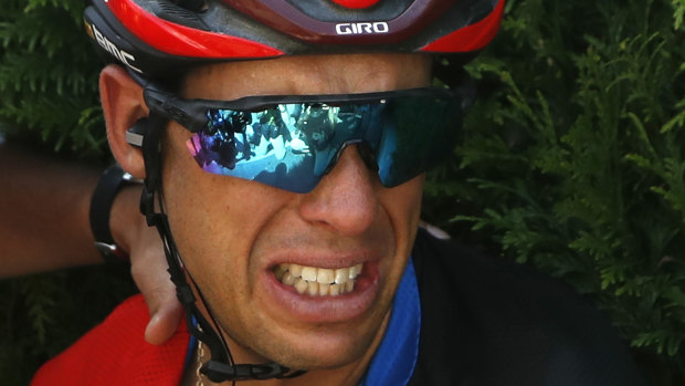 Cruel twist of fate: Porte grimaces in pain after the unexpected crash, which took place before the stage reached the treacherous cobblestones.