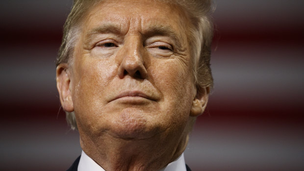 President Donald Trump pauses as he speaks during a campaign rally at Florida State Fairgrounds Expo Hall.