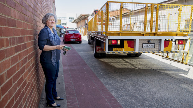 A truck backs up along an easement adjoining Karen Paxton's small business in Fyshwick. The valuation on her block went up 300&#37; in 2016-17, affecting her business.