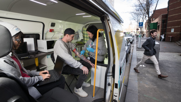 Cohealth street doctor Kate Coles treats Tim Williams in the mobile medical clinic.