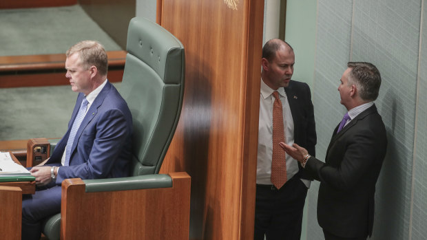 Treasurer Josh Frydenberg in discussions with Chris Bowen in Parliament.