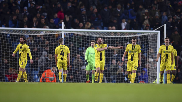Dejected Burton players head back to the middle after Manchester City's sixth goal.