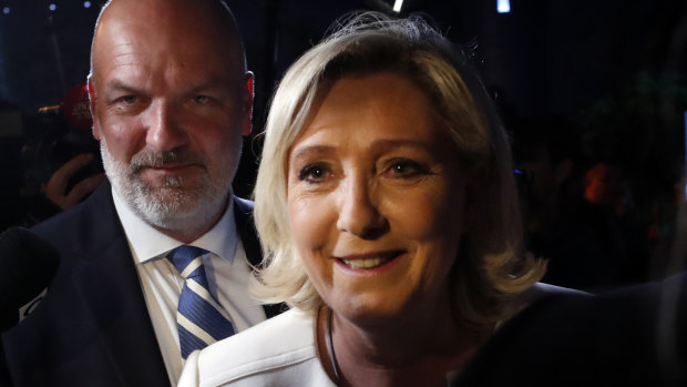Far-right National Party leader Marine le Pen, escorted by her bodyguard Thierry Legier, after she declared victory in the European Parliament election over pro-EU French President Emmanuel Macron.