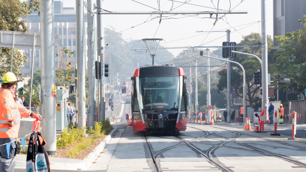 A tram rolls along High Street at Randwick.