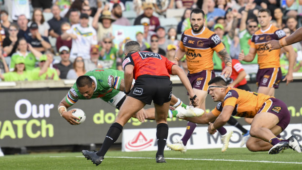 Outta my way: Joey Leilua muscles his way over for a Raiders try.