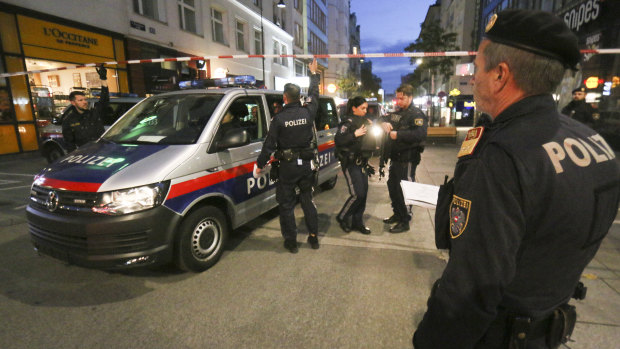 Police patrol the scene near a deadly shooting in Vienna.