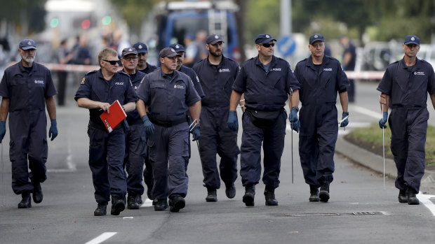 Police officers search the area near the Masjid Al Noor mosque after the terror attack in Christchurch.