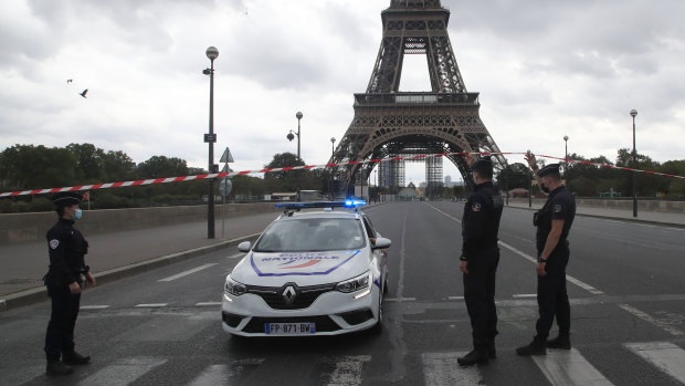 French police officers secure the bridge leading to the Eiffel Tower after a phone-in bomb threat. 