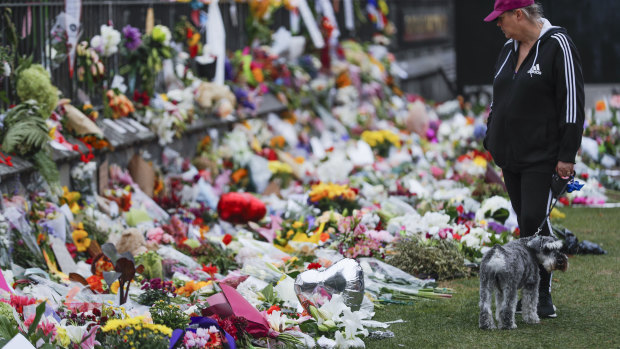 Mourners lay flowers on a wall at the Botanical Gardens in Christchurch, New Zealand.