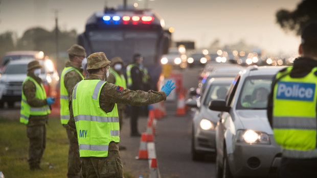 ADF personnel assist Victoria Police at a roadside checkpoint on the Geelong Freeway.