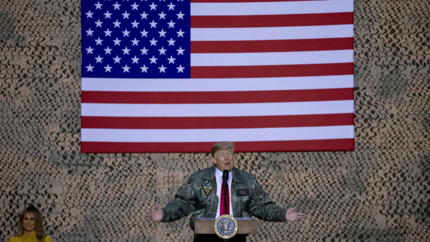 Trump flies the American flag in Iraq as he addresses the troops.