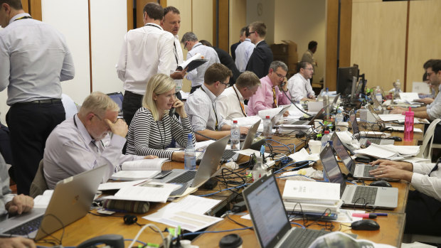 Fairfax Media journalists work on coverage of the 2018-19 budget.