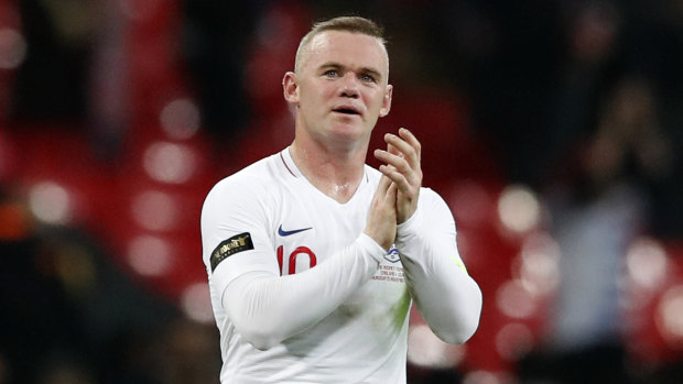England's Wayne Rooney greets fans at Wembley Stadium.