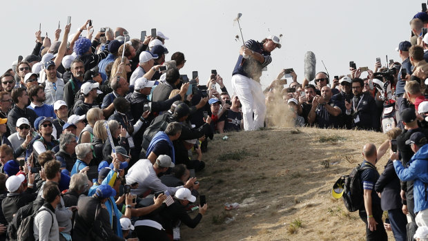 Plenty of fans: Phil Mickelson plays out of the rough while onlookers watch.