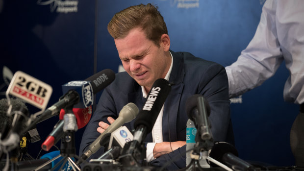 Facing up: Steve Smith is comforted by his father Peter while facing the media at Sydney Airport.