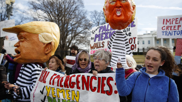 People gather in front of the White House on Presidents' Day to protest against Donald Trump declaring a national emergency along the southern border.