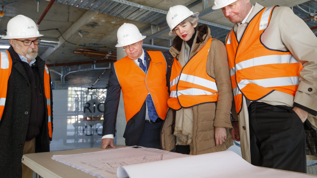 ANU vice-chancellor Brian Schmidt (centre left) and philanthropists Louise and Graham Tuckwell (right) view the plans for Wright Hall, a student residence set to open next year.