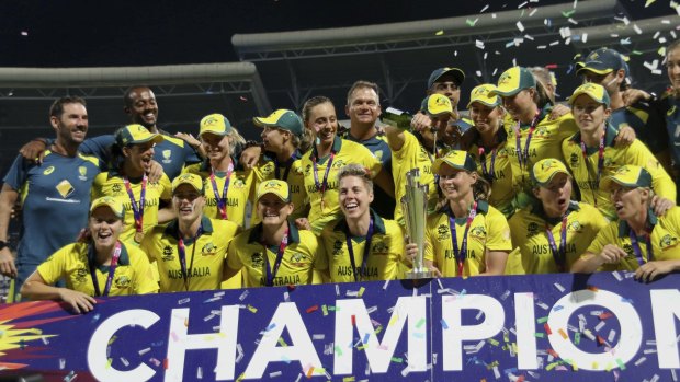 The Aussies celebrate with the trophy.