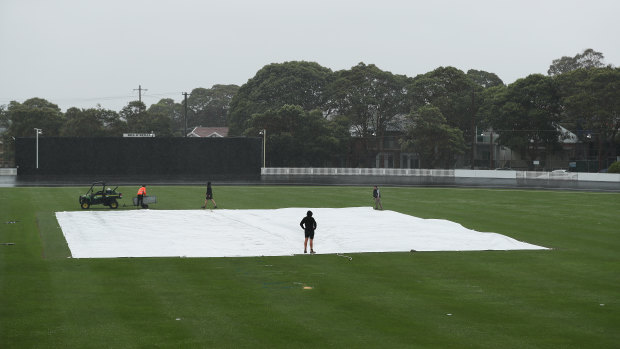 Covers on the field as rain forces a delay during Sunday's WBBL Melbourne derby.