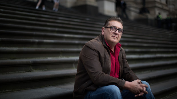 Frank D'Abaco, the father of an autistic teen who said he was bashed unconscious by up to eight men, protests on the steps of Parliament over what the family perceive as government inaction on "gangs" in Melbourne's suburbs.
