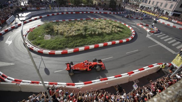 Prancing in the streets: Ferrari driver Kimi Raikkonen during a Formula One cars parade through downtown Milan ahead of Sunday's Italian Grand Prix.
