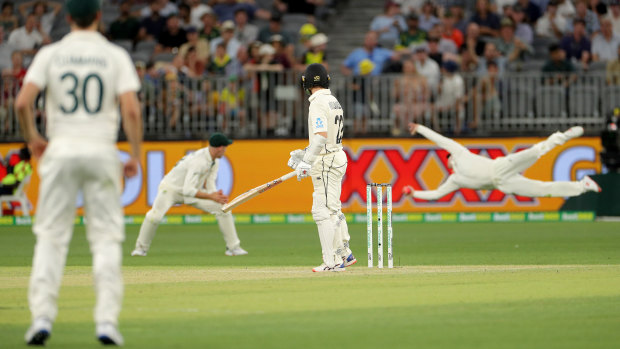 Reaction time: Steve Smith dives to catch and remove Kane Williamson.