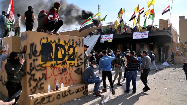 Pro-Iranian militiamen and their supporters outside the US embassy in Baghdad on Wednesday.