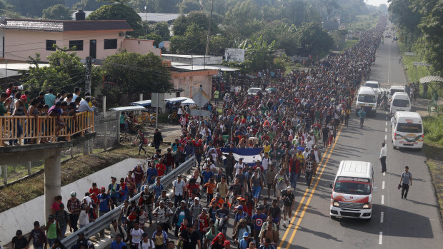 Central American migrants walking to the US start their day departing Ciudad Hidalgo, Mexico, on Sunday.