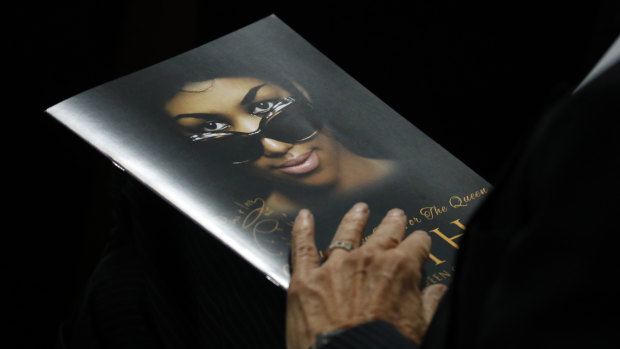 A attendee holds a program during the funeral service for Aretha Franklin.