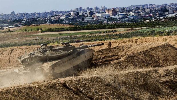 Israeli tank takes a position at the Gaza Strip border, as Israel carried out a “wide-scale” strike on Iranian targets in Syria.