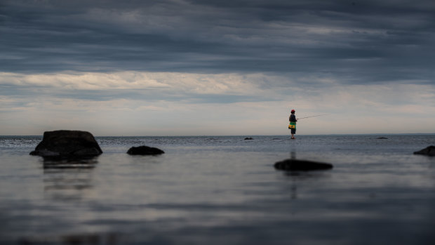 As the storm clouds roll in, one fisherman finds peace on a Williamstown beach.