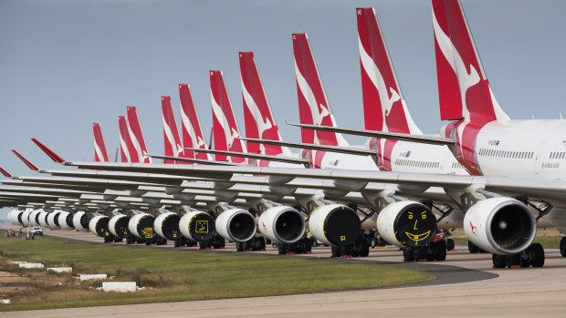 Qantas and Jetstar planes grounded at Avalon Airport, with engine covers secured with yellow tape.