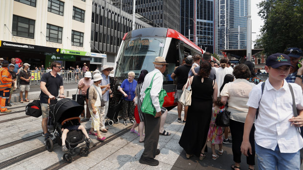 Crowds surround a tram at the Town Hall stop on opening day in December.